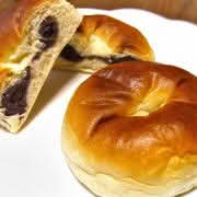 A plate of two Anpan, a traditional Japanese sweet bread filled with red bean paste